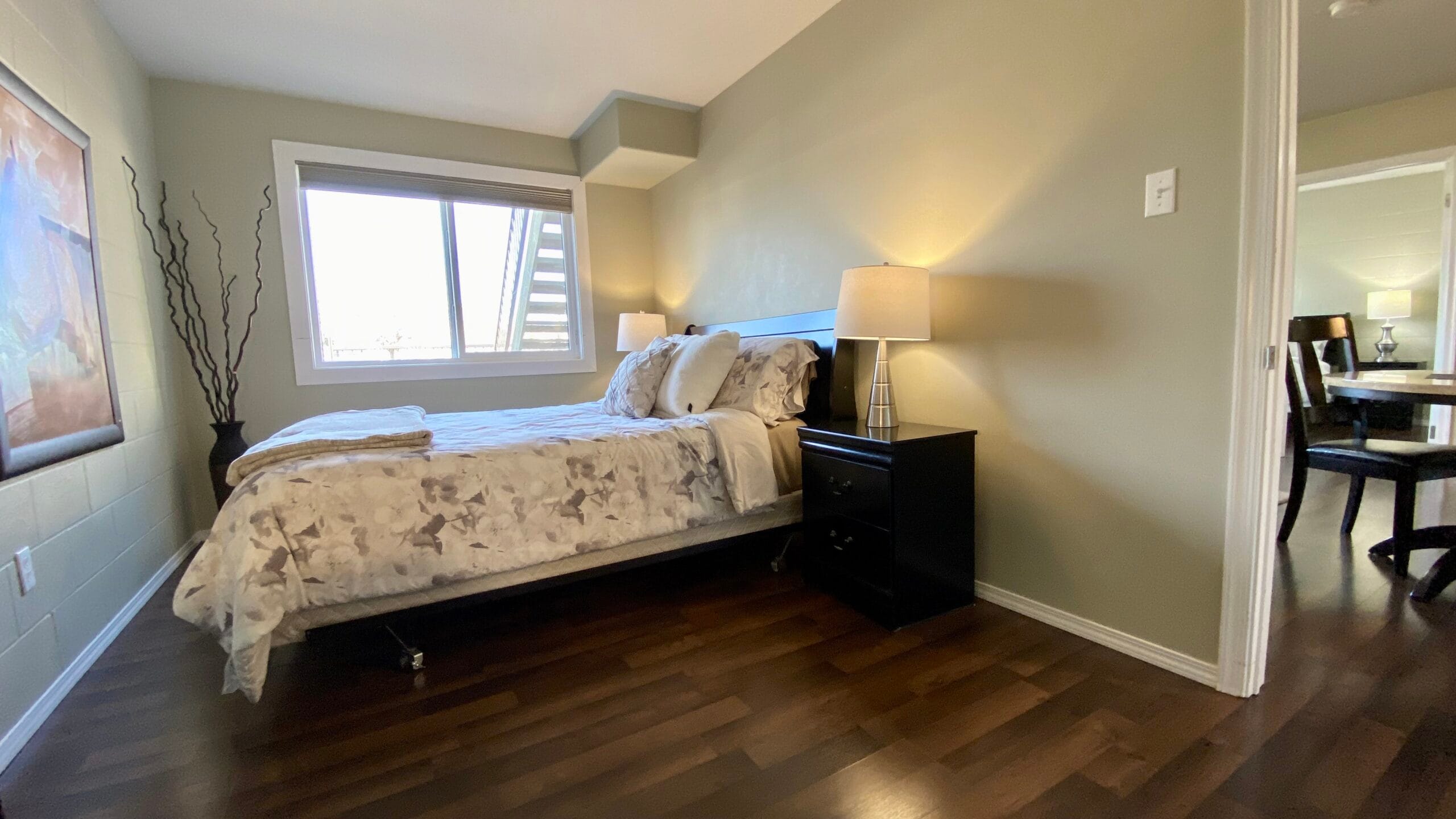 1st bedroom with Queen in 2-Bed/1-Bath fully furnished rental condo in Saskatoon, main floor unit.